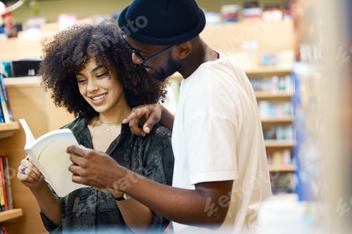 Preview: Books, library and student couple reading together for break or conversation about study notes. Un