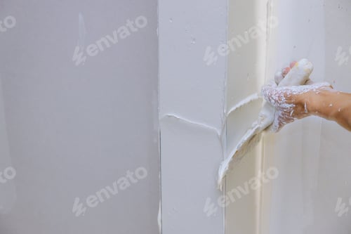 Preview: Renovation the wall with putty spreading plaster on wall.
