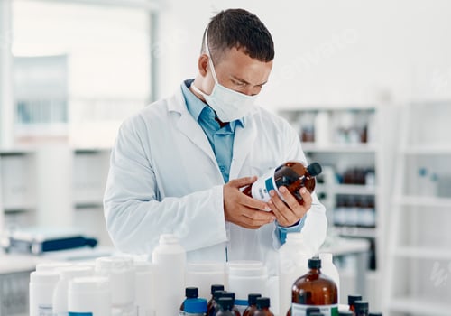 Preview: Unmasking the virus. Shot of a young scientist analysing medication in a laboratory.