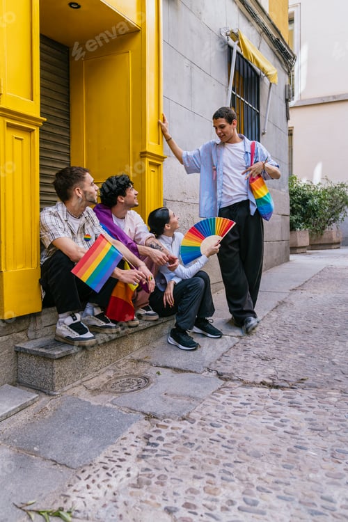Preview: Young diverse friends celebrating lgbtq plus pride in urban street