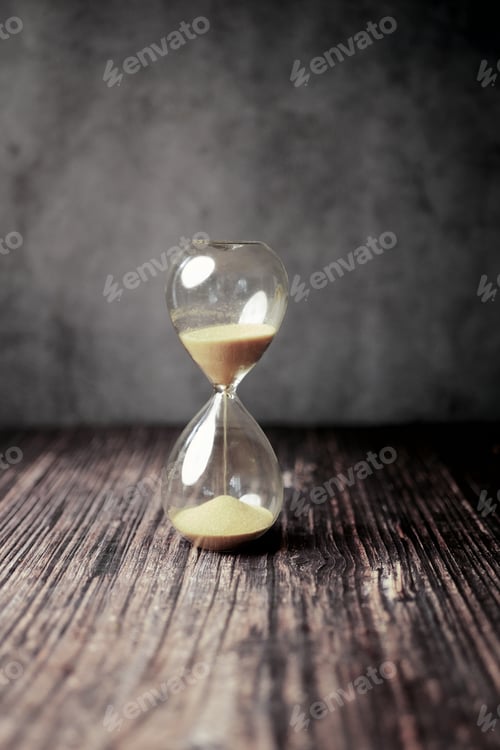 Preview: hourglass on table, sand flowing through the bulb of sandglass