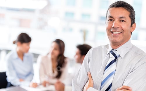 Preview: Successful Business Man At The Office With His Team