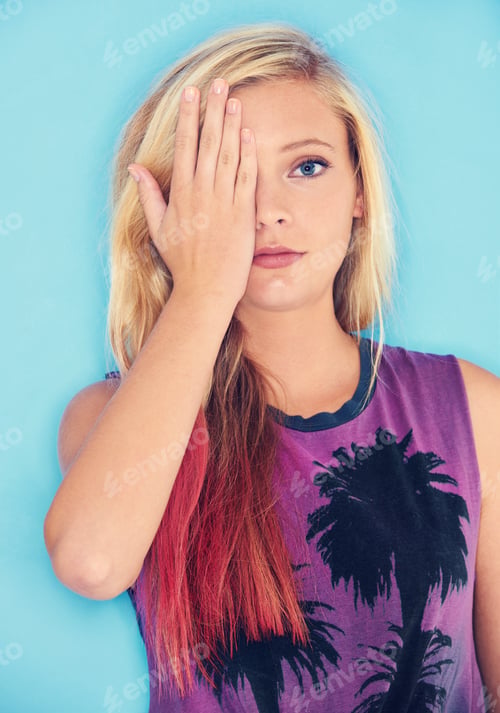 Preview: Serious about her style. Studio shot of an attractive and trendy young woman covering her one eye.