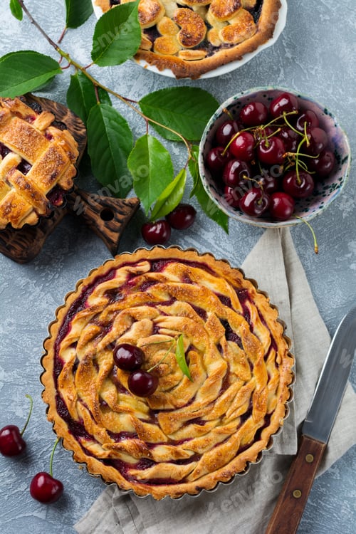Preview: Homemade open cherry pie with lattice on a gray concrete background. Selective focus. Top view
