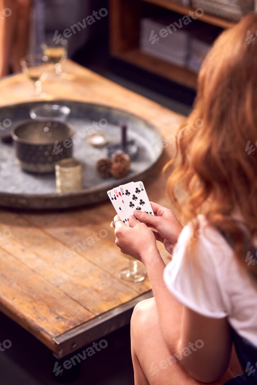 Preview: Close Up Of Woman At Home Playing Cards With Friends On Games Night
