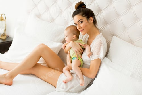 Preview: Woman Holding a Baby in a Bedroom