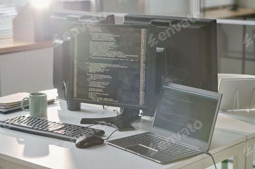 Preview: Workplace of computers with codes on screen