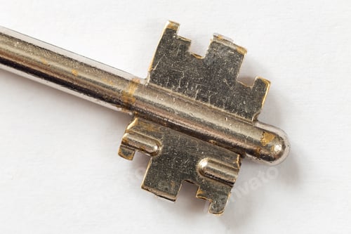 Preview: Close-up detail of old well-used steel key isolated on white copy space background. Safety and