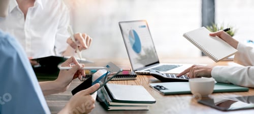 Preview: diverse coworkers working together in boardroom, analyzing and planning business strategy.