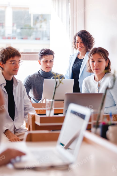 Preview: Group of business people working at desk in office