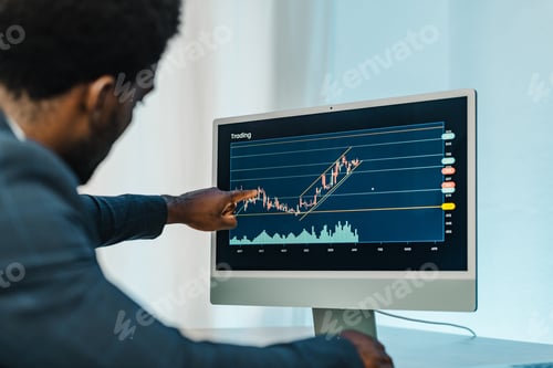 Preview: Man Analyzing Business Trading Chart on Computer