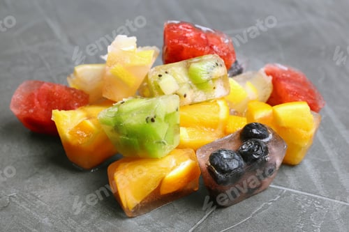 Preview: Fruit and berry ice cubes on grey background