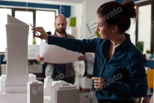 Preview: Architecture office partners looking at blueprints and plans