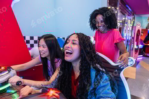 Preview: Young women playing arcade game and having fun together