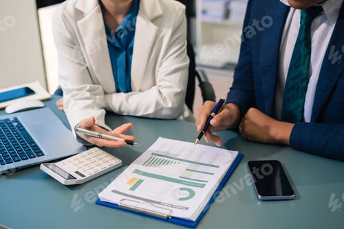 Preview: Business people discussing on performance revenue in meeting.