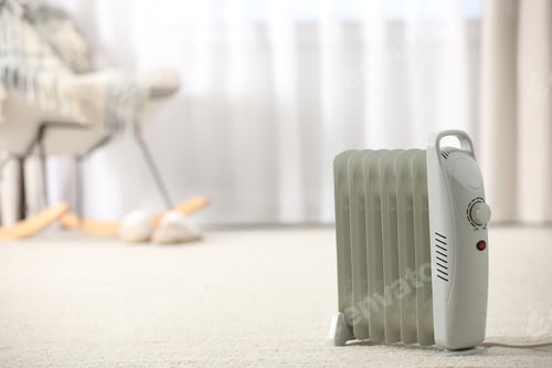 Preview: Modern electric heater on floor at home. Space for text