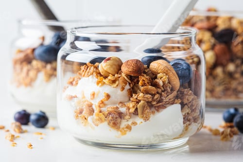 Preview: Granola with nuts, yogurt and berries in jar.