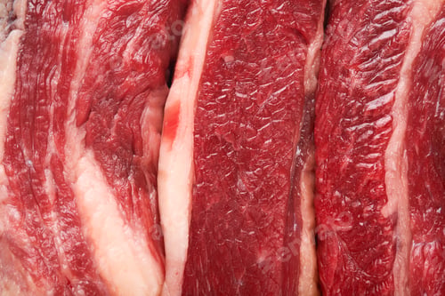 Preview: Texture or background steak beef. Raw steak New York with rosemary and spices on a piece of parchmen