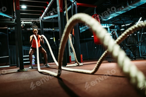 Preview: Powerful attractive muscular woman battle rope workout at the gym