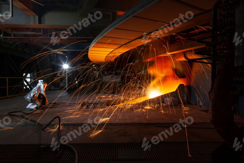 Preview: Two factory workers igniting a furnace in an industrial factory.