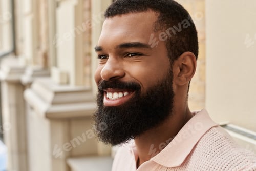 Preview: Smiling man enjoying his journey in a vibrant modern city