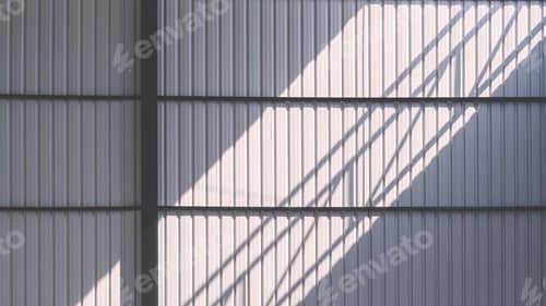 Preview: Light and shadow on gray corrugated steel wall inside of new warehouse is under construction