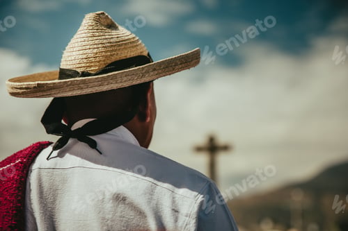 Preview: Mexican man in Traditional clothes and hat looking at the sky at the annual dancing parade holidays