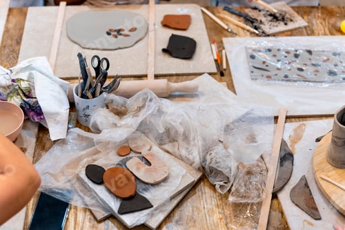Preview: Ceramic Workshop. Ceramic pieces with tools on the work table.
