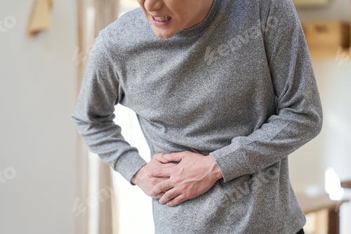 Preview: Asian man suffering from pain in his side