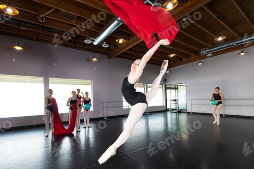 Preview: Group of young ballet dancers playing and having fun in dance studio with colorful fabric
