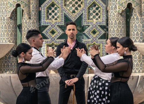 Preview: group of pupils dressed in flamenco dancing in pairs in front of their teacher looking at the camera