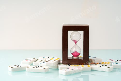Preview: Hourglass and domino tiles on blue background. Time limit concept
