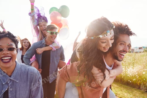 Preview: Group Of Friends Walking Back To Tent After Outdoor Music Festival With Balloons And Smoke Flare