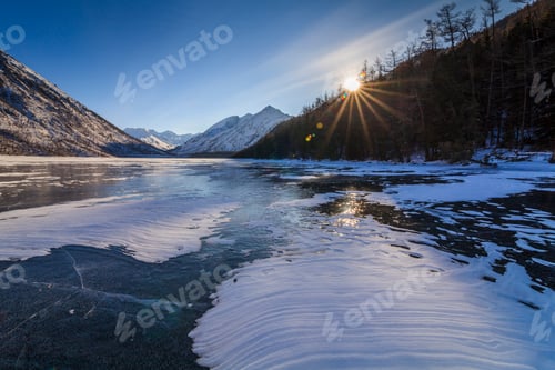 Preview: Scenic winter landscape with mountains and icy lake