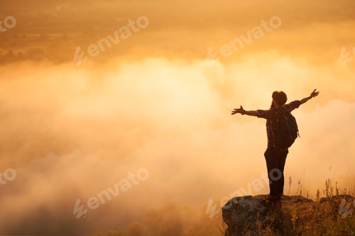 Preview: Man on stone above clouds