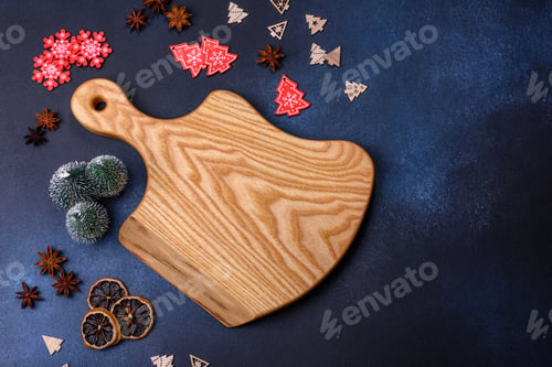 Preview: Elements of Christmas decorations, sweets and gingerbread on a wooden cutting board