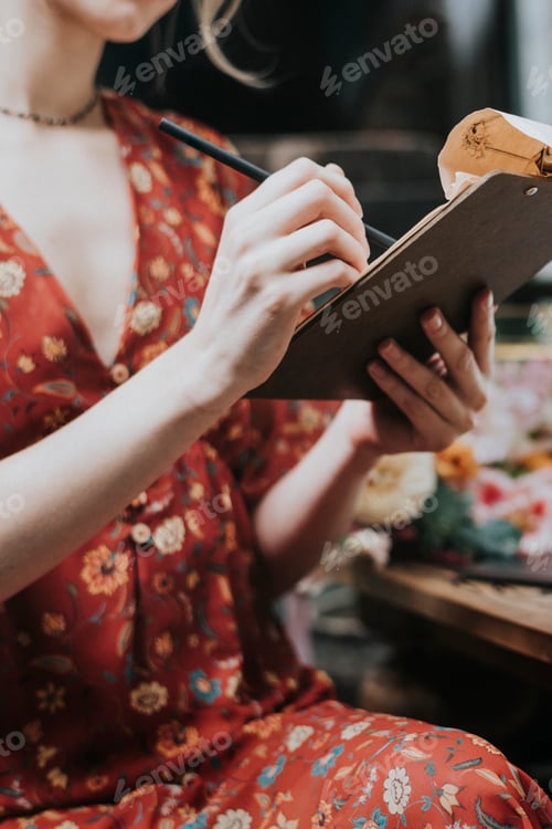 Preview: Florist writing an order note