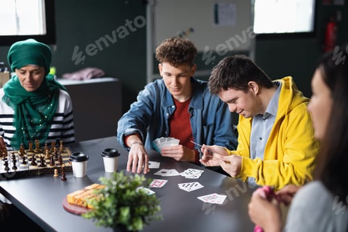 Preview: Group of people playing cards and board games in community center, inclusivity of disabled person