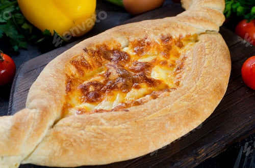 Preview: Khachapuri with cheese closeup. Adjarian open pie with mozzarella.