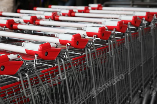 Preview: Many empty metal shopping carts near supermarket outdoors, closeup