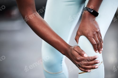 Preview: My knee really hurts. Cropped shot of a young woman holding her knee in pain while at the gym.