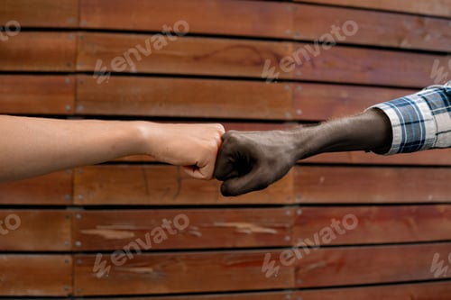 Preview: hands of afro american and european men, unity concepts