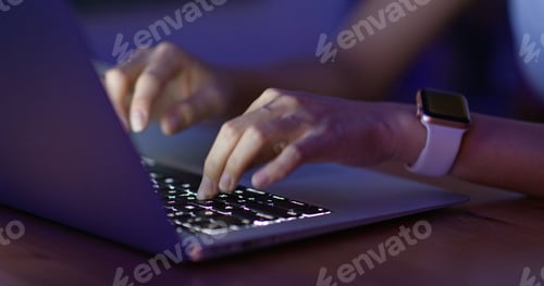 Preview: Woman work on laptop computer at night