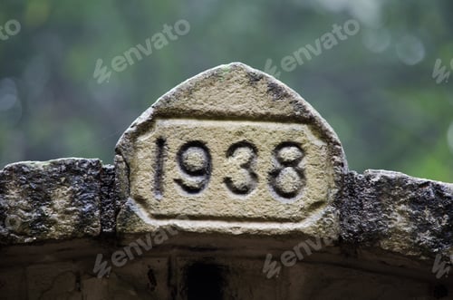 Preview: Closeup shot of numbers on weathered stone outdoors