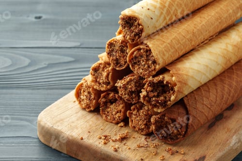 Preview: Waffle tubes with chocolate filling on wooden board