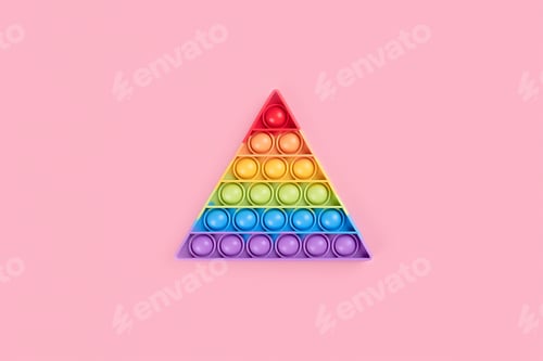 Preview: Bright rainbow toy antistress for children and adults on a pink background