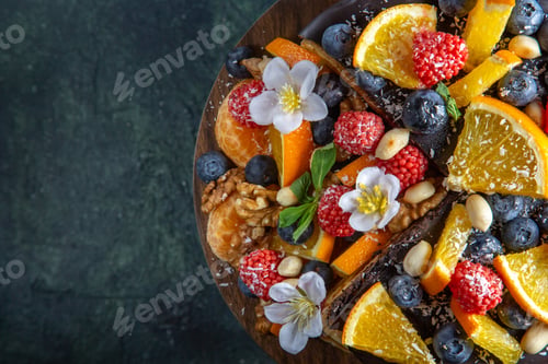 Preview: top view delicious fruit cake with chocolate syrup on round wooden desk dark background tea pie