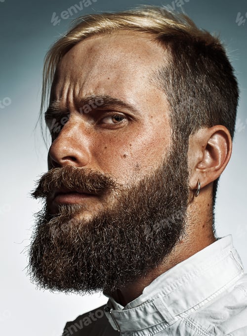 Preview: Portrait of hipster bearded man's side face.