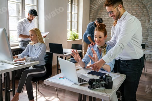 Preview: Portrait of creative designer team smiling while working together in the modern office.