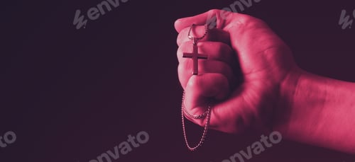 Preview: Praying with a rosary. hand of Catholic man with rosary on black background.